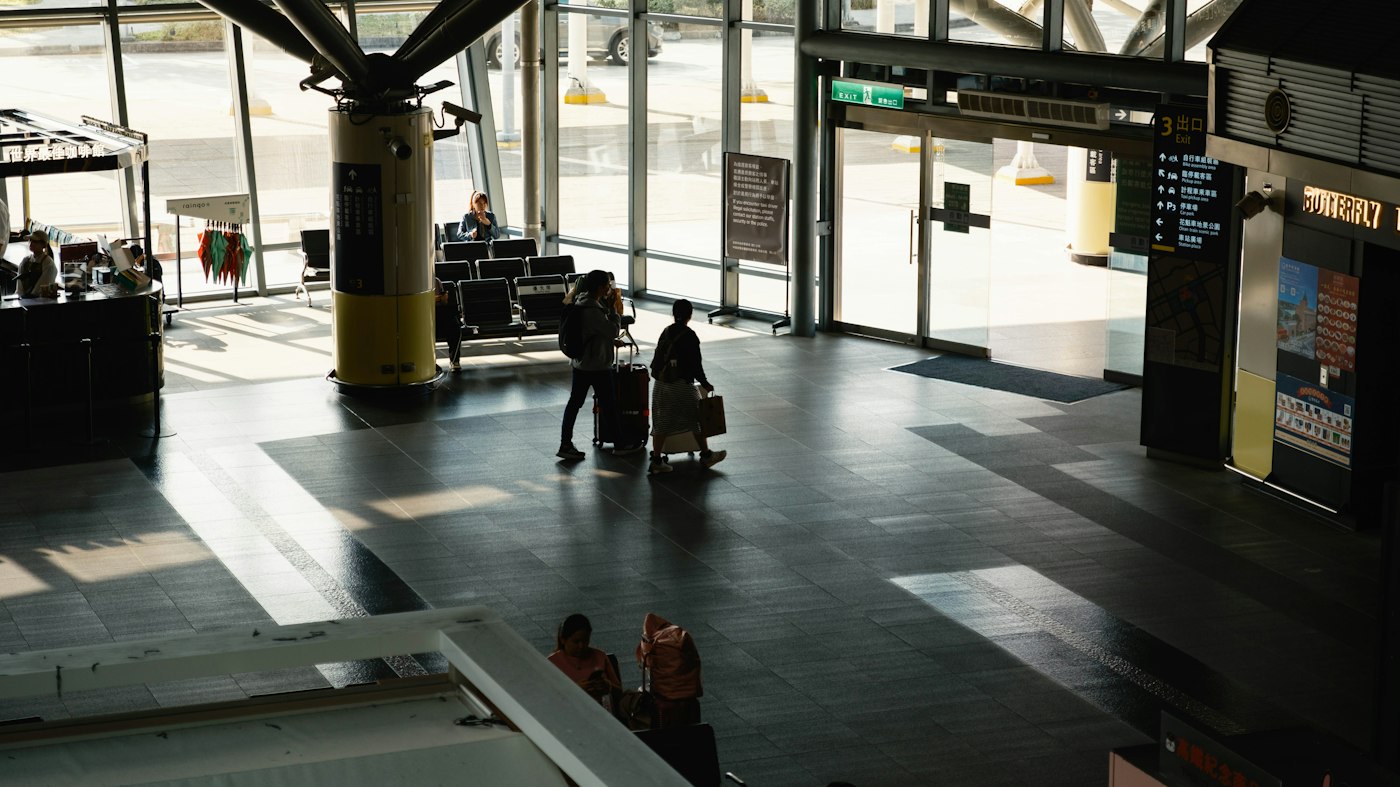 Travellers with luggage in a modern airport terminal